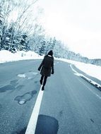 back view of walking girl on road at winter, japan, hokkaido