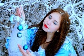 girl in a blue dress on a background of snowy nature