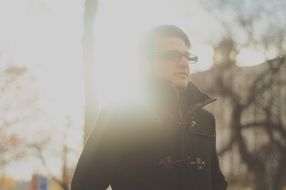 man in a jacket in the bright sun