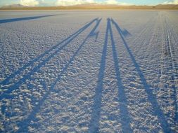 people shadows on salar uyuni surface, Bolivia