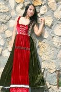 girl in a historical dress near the wall