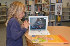 a girl is leafing through a book