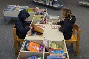 children boy and girl pin the library