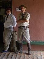 man in a cowboy costume standing near the wall