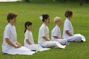 women in white meditator on the field