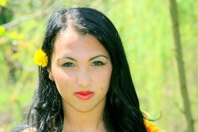 portrait of a girl with black hair and dandelion
