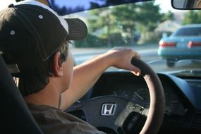 man behind the wheel of a Honda