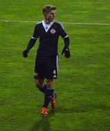 young caucasian male soccer player on field