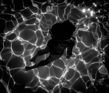 Black and white photo of the woman in water