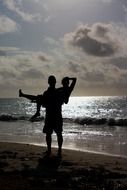 silhouette of a romantic couple on the beach