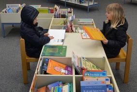 Children in the library choosing books to read