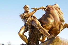 man and bull gold sculpture