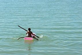 infant boat with paddles on an inflatable boat on the sea