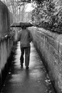 old man with umbrella at rain, black and white