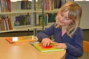 Girl with a book in the library