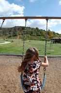 girls swing in park