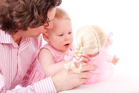 baby holding a doll