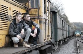 young guys on the edge of the wagon