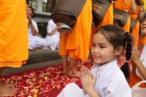 little girl prays in thailand