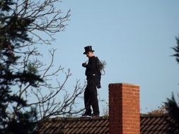 chimney sweeper on tiled roof