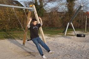 swinging boy on the playground