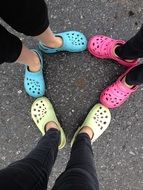 Children with colorful croksits on their legs