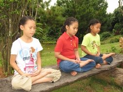 three children in the lotus position