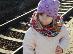 sad child girl at railway