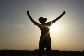 silhouette of a young woman at sunset