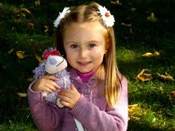 little cute girl with a soft toy