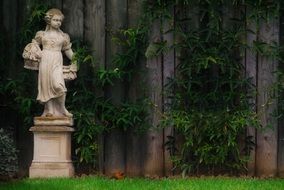 stone statue of a girl of an ornamental garden