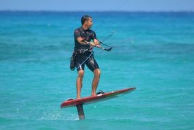 man engaged kite surfing