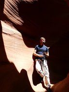 A man with a camera in the canyon of antelope canyon