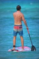 man paddling on the surfboard