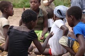 group of african children sit on ground