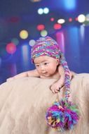 baby in a multicolored cap