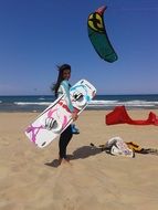 Girl is doing kiteboarding on water