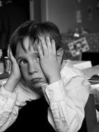 black and white photo of a disappointed boy