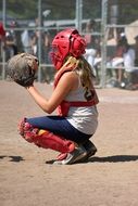 girl playing softball in a helmet