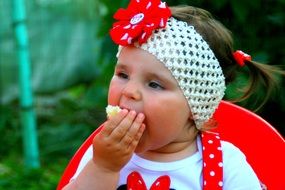 little girl eating an apple