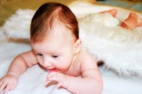 child with white fluffy angel wings