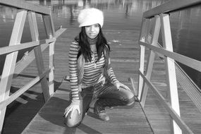 model in a hat on the bridge black and white photo