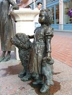 little girl with dog, statue on street, hungary, szeged