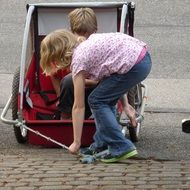 sister wants to ride brother in bike trailer