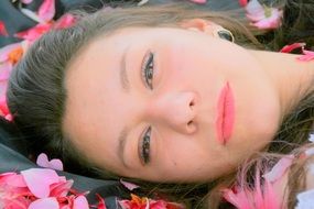 portrait of a girl on the background of pink petals