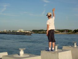 Greeting boy near the river