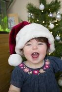 little girl in christmas hat