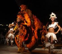 dancers on stage in colorful costumes in light