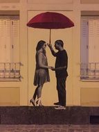 couple in love under an umbrella on a mural on the wall