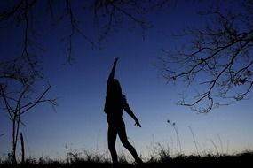 silhouette of a dancing girl at dusk